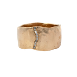 Close-up of SIGR WATER ring showcasing wavy edges and hammered texture