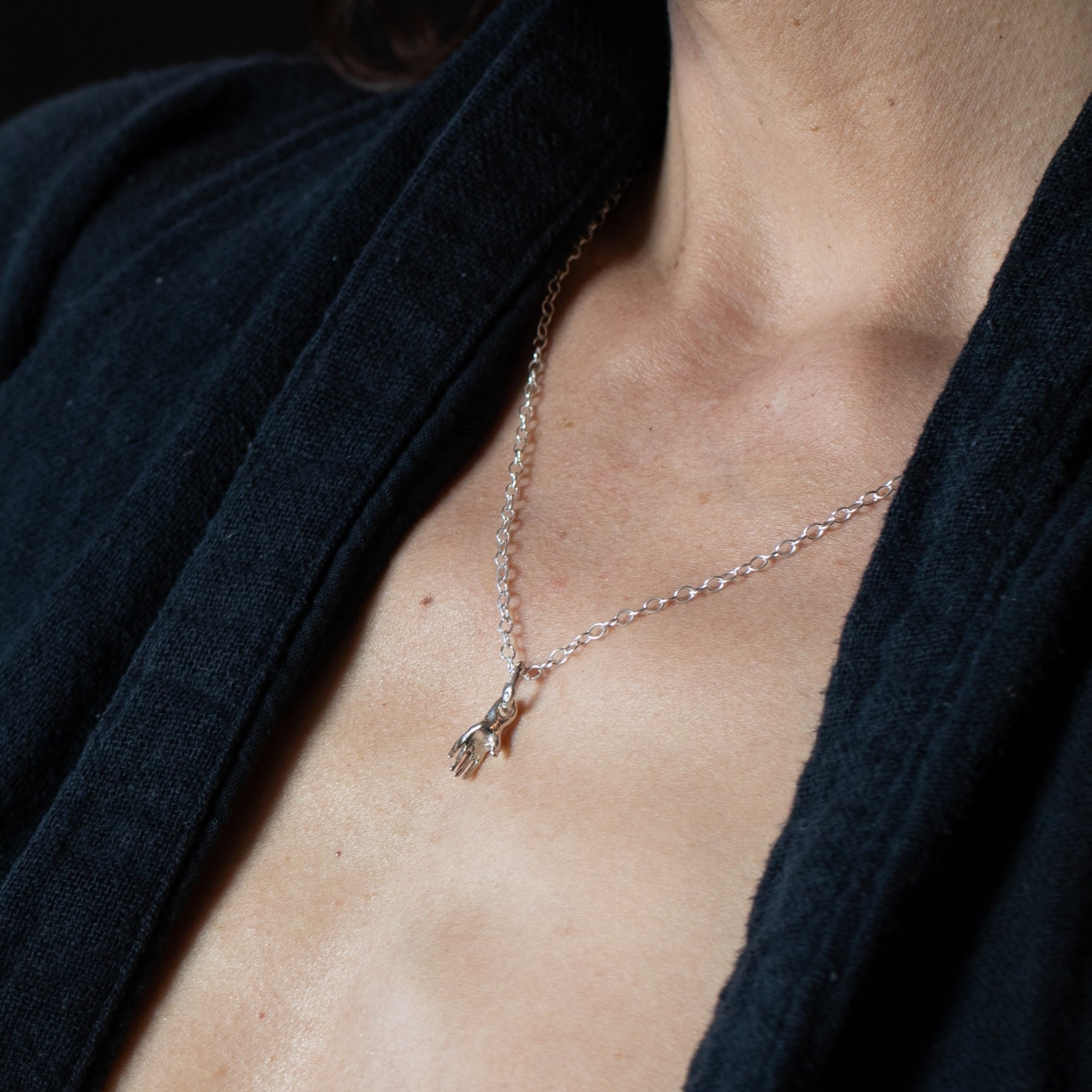 Necklace with a small hand pendant  in sterling silver