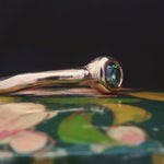 Close-up of Madrone Solitaire ring showcasing smooth, undulating band design