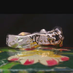 Close-up of No. 83 ring showcasing hand-carved texture and gemstone details