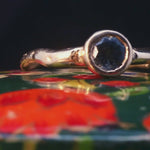 Close-up of Madrone Solitaire ring showcasing smooth, undulating band design