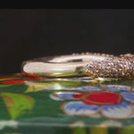 Close-up of MADRONE ring showcasing raised pavé setting and scuffed texture