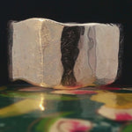 Close-up of Hand-Carved SIGR WATER Ring Showcasing Textured Finish