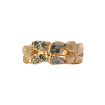 Close-up of ERNA ring showcasing four-petal floral design and hammered texture