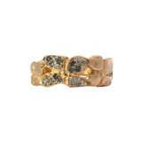 Close-up of ERNA ring showcasing four-petal floral design and hammered texture