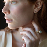 Close-up of hand-carved huggie hoops with champagne diamonds