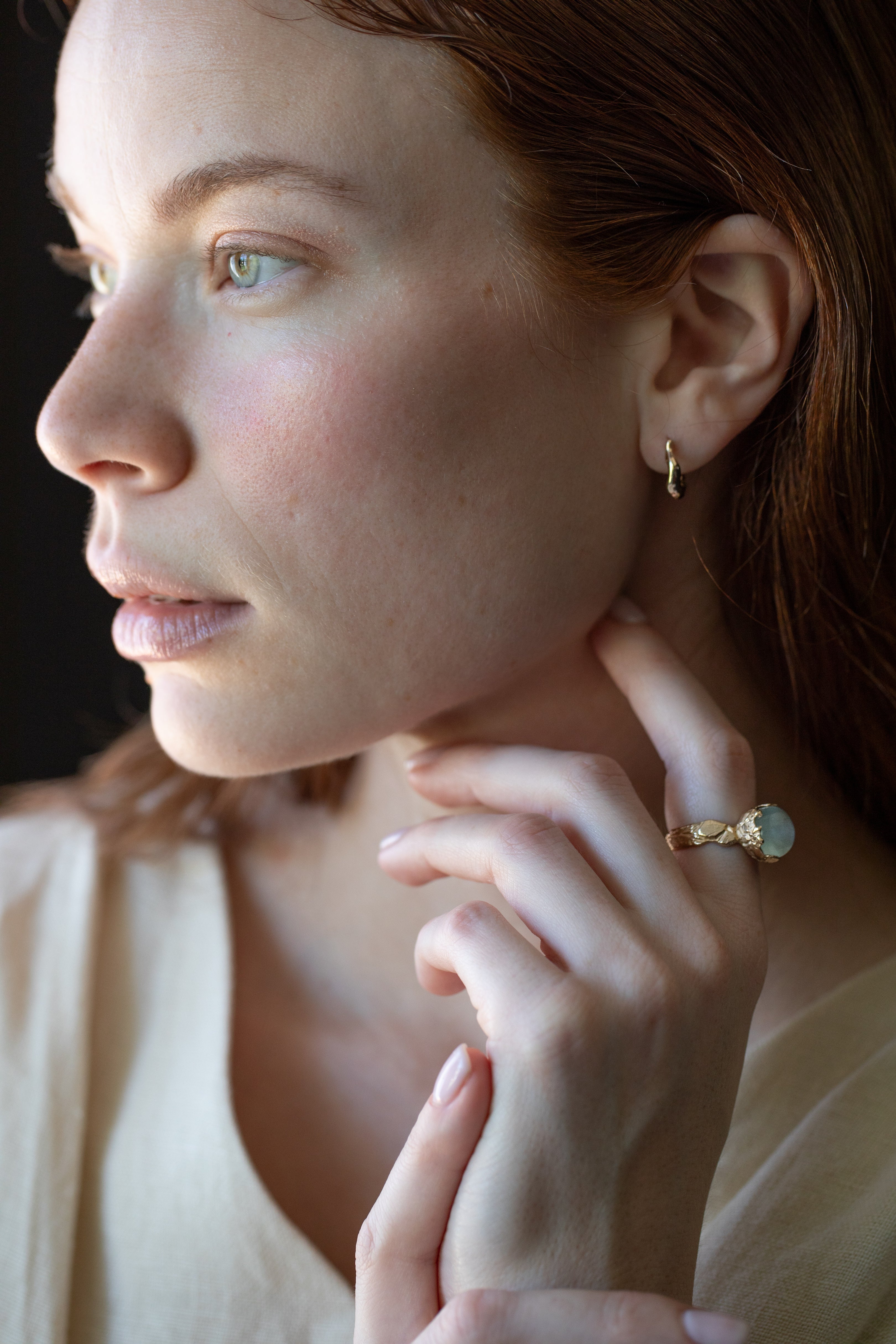 Close-up of hand-carved huggie hoops with champagne diamonds
