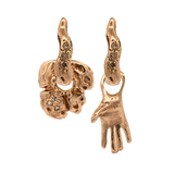 Close-up of hand-carved right-hand charm with champagne diamond