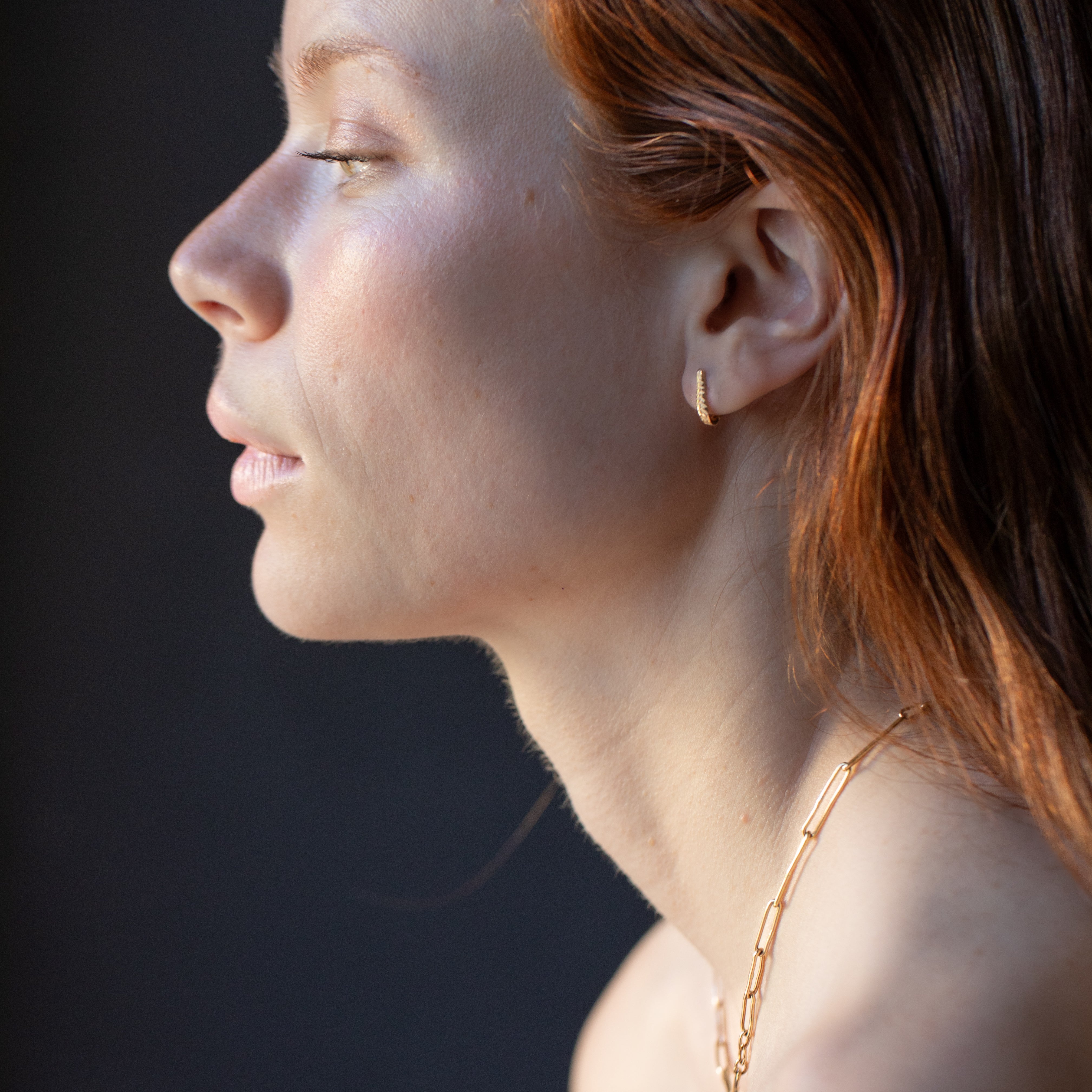 Model Wearing Crooked Fern Mini Hoop Earrings with Elegant Style

