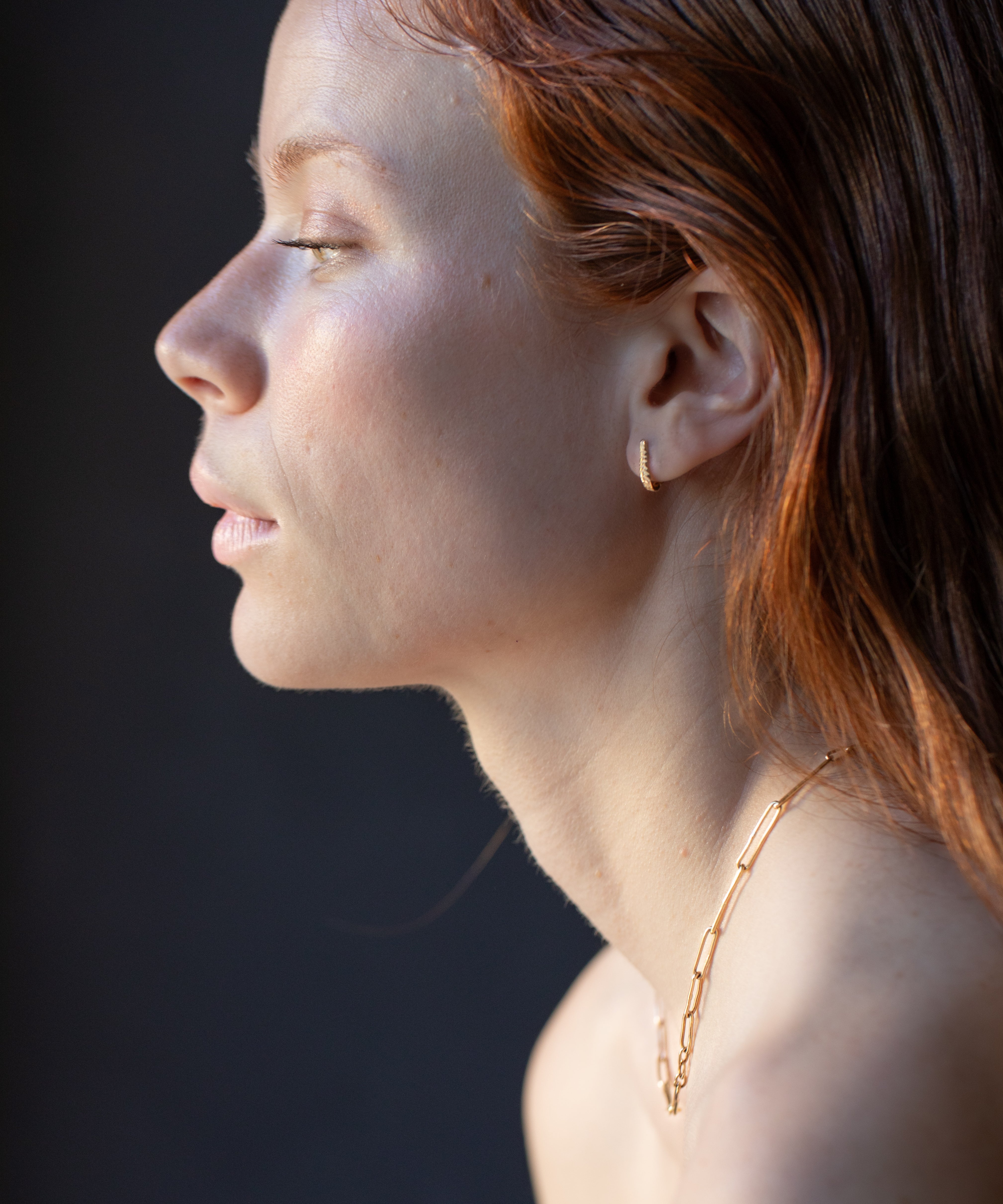 Model Wearing Crooked Fern Mini Hoop Earrings with Elegant Style


