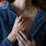 Model Wearing SIGR WATER Medium Band Ring with Sculptural Design

