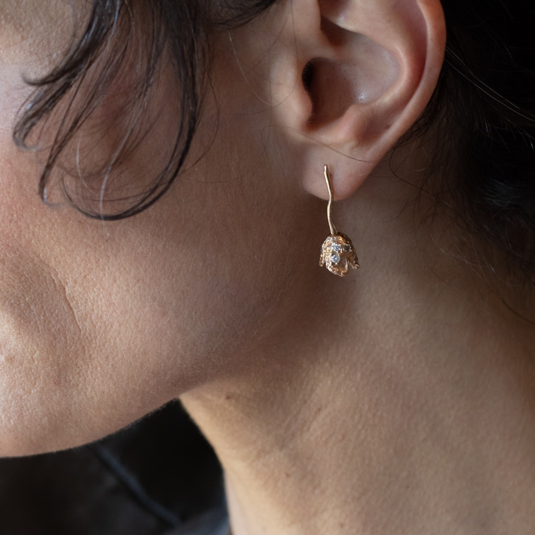 RORA Earrings worn on ear, sculptural lost wax cast detail