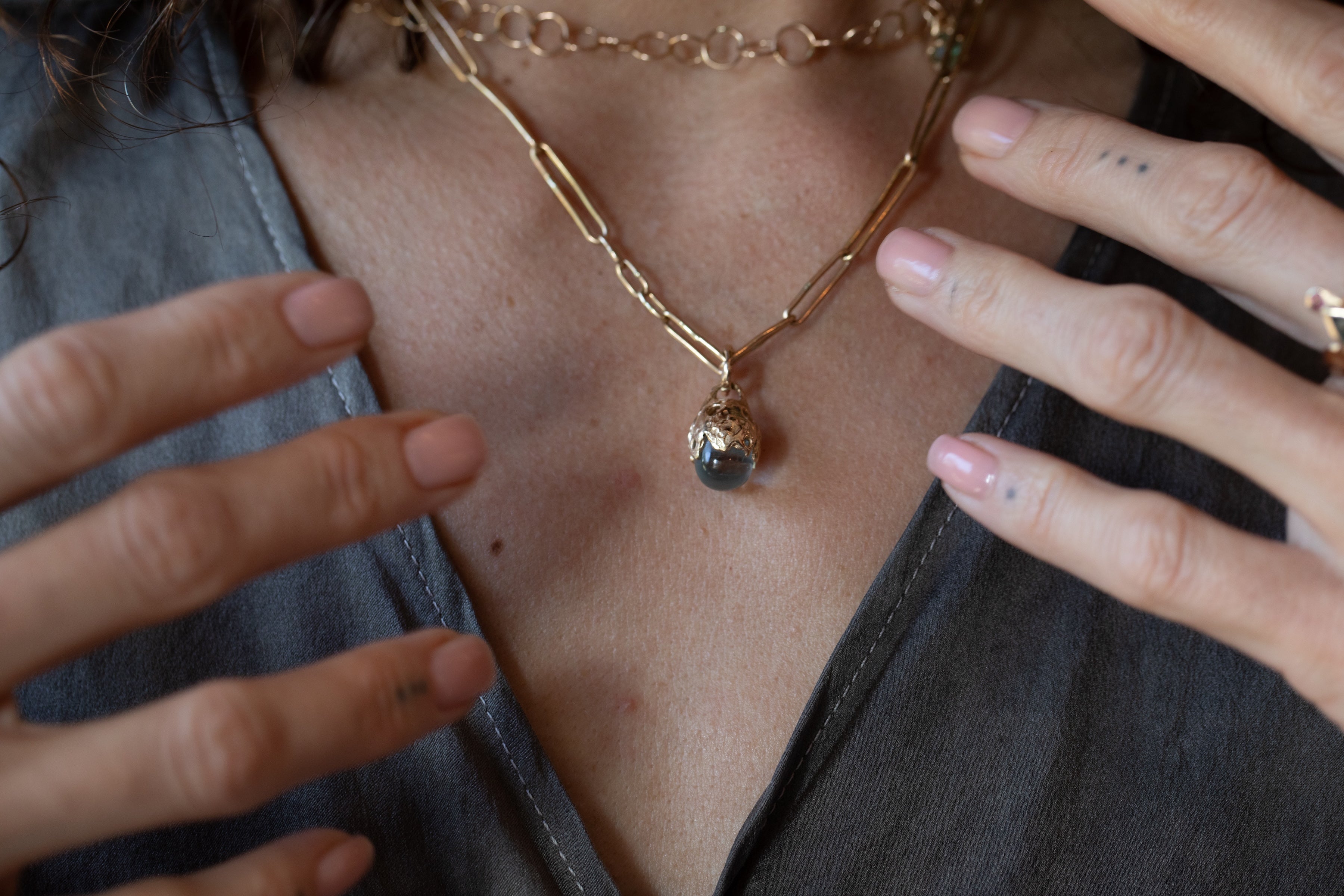 SPERO Pendant texture close-up showing hand-carved detail, 14K Fairmined gold
